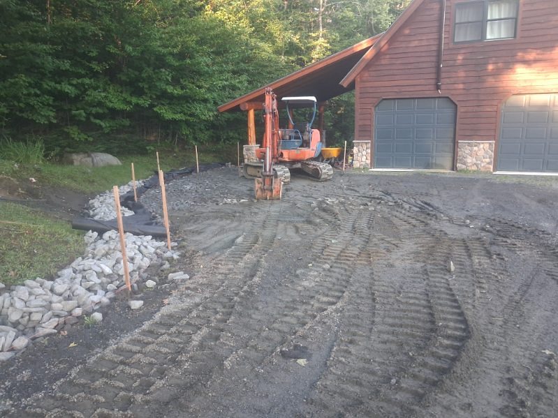Stone-lined channel beside the drive